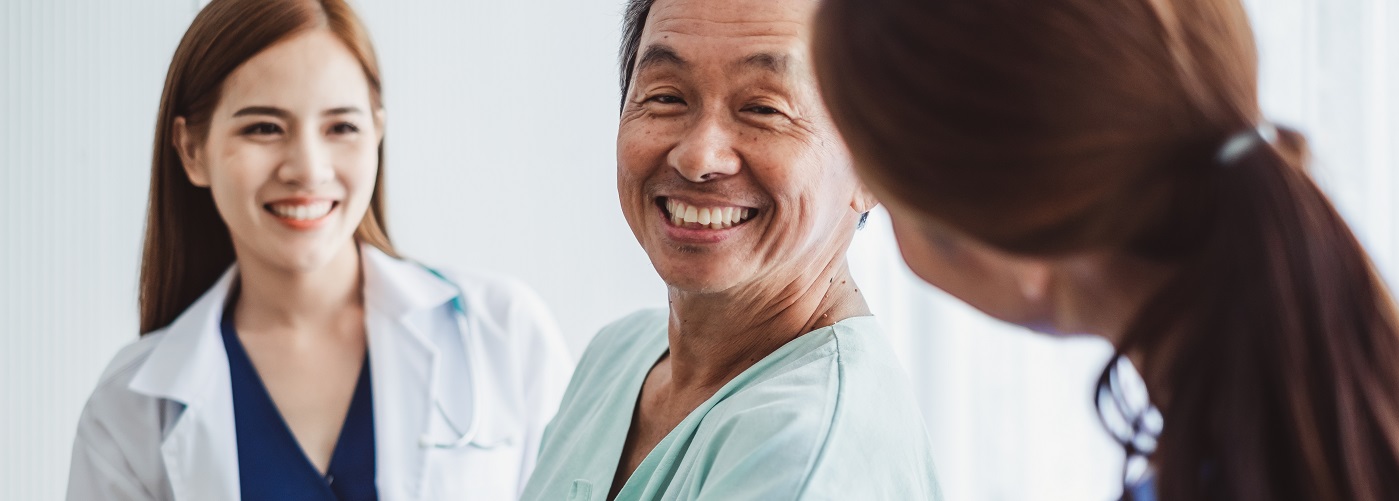 Two doctors assisting old man image