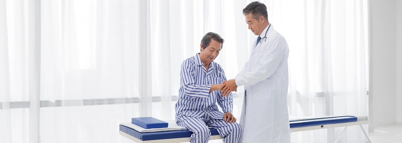 Doctor examining a gout patient at Gleneagles Hospitals